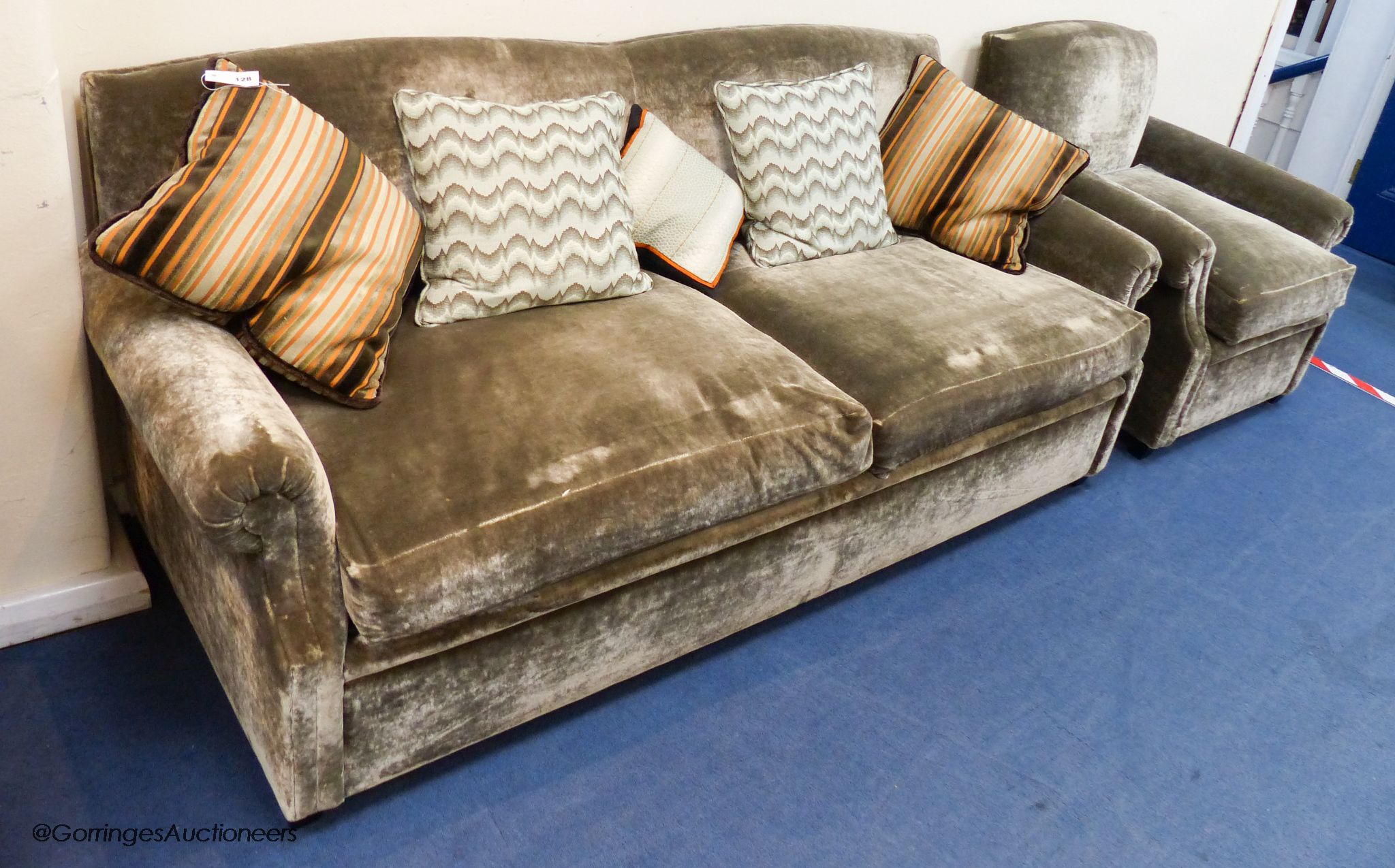 A grey velvet two seat sofa bed, approximately 191 cm wide and a matching armchair, various scatter cushions